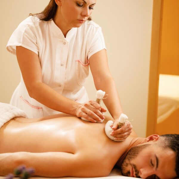 female-therapists-massaging-back-man-with-thai-herbal-compress-health-spa (1)