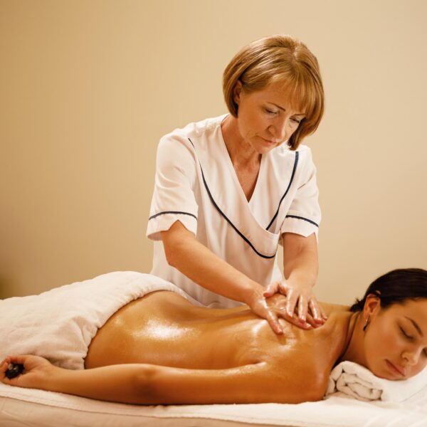 young-woman-having-back-massage-by-female-therapist-spa-focus-is-massage-therapist